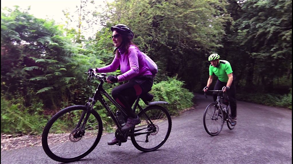 Enid I don't like hills peddling away merrily, meanwhile Eric's out of the saddle!